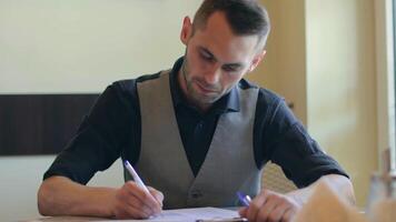 Handsome Young Man is Writing a Document in Pizzeria Cafe. Office Employee Has a Break. Middle Close-Up View, Dynamic Shot video