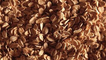 Oat Flakes Background Rotating Left - Top View, Low Key Light. Scattered Dry Oat Flakes. Healthy Breakfast and Diet Eating Ingredients video