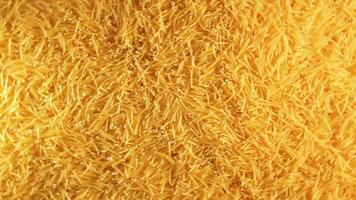 Background of Uncooked Golden Noodles that Rotating Clockwise - Top View. Texture of Dry Vermicelli Turning Around. Raw Pasta - Right Rotation video