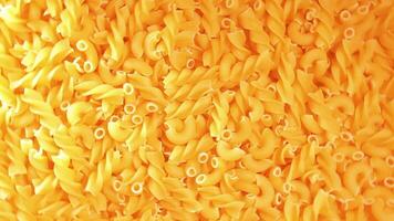 Uncooked Fusilli and Chifferi Rigati Pasta - Top View. Fat and Unhealthy Food. Classic Dry Macaroni, Rotating Background. Raw Different Macaroni Pasta Texture - Rotate Right video
