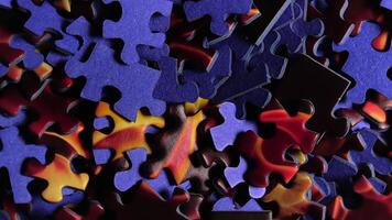Background of Colored Puzzle Pieces that Slowly Rotating Counterclockwise - Top View, Close-Up. Texture of Incomplete Red and Blue Jigsaw Puzzle with Low Key Light - Left Rotation video