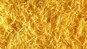 Background of Uncooked Noodles that Slowly Rotating Counterclockwise - Top View, Close-Up. Texture of Dry Vermicelli Turning Around. Raw Pasta - Left Rotation video