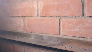 The Petard Was Placed on a Metal Surface by the Hand Than Explode Against a Brick Wall. Many Small Particles Flew in a Different Directions - Static Shot video