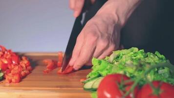 Chef in Black Uniform is Slicing Red Paprika and Preparing Vegetable Ingredients for Cooking. Man in a Kitchen is Cutting Red Pepper for Vegetarian Dish. Healthy Food Concept video