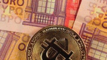 Bitcoin Coins on the 50 Euro Banknotes - Top View, Macro. Euro Money Cash and Cryptocurrency. A Lot of Fifty Euro Bills. Finances, Blockchain and Electronic Money Concept - Slow Rotation Right video