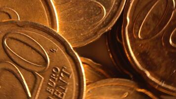 Scattered 20 Euro Cent Coins, Rotating Money Background - Top View, Macro. Euro Money Currency. A Lot of Twenty Cent Cash. Golden Eurocents. Business, Finances and Money Saving Concept - Rotation Left video