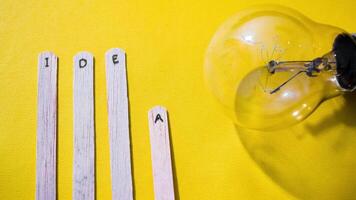 Stop motion Ice cream Stick with word Idea with lightbulb over yellow background video