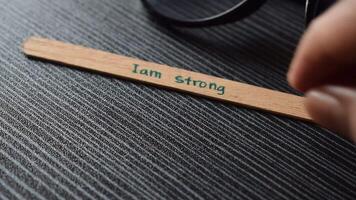 Ice cream Stick with word I am Confident on table with eyeglasses video