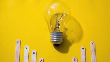 Stop motion Stick Ice cream with word Creativity with lightbulb on yellow background video