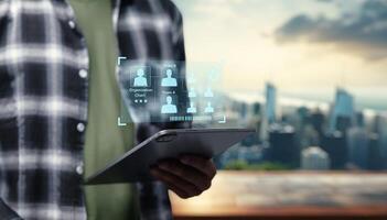Man using tablet with social network icons on background photo