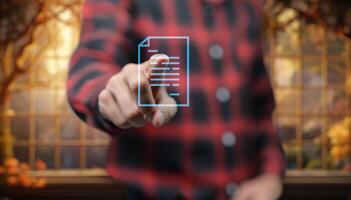 A person is holding a document with a digital screen photo