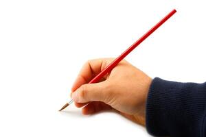 A person holding a red pencil in their hand photo