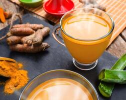 Turmeric and ginger tea on a wooden table photo
