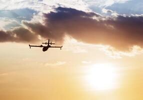 Silhouette of an airplane at sunset. photo