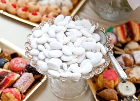 A table with a bunch of white cookies photo
