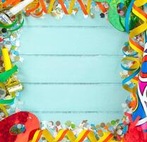 A blue background with colorful confetti and party supplies photo