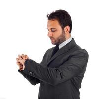 A man in a suit checking his watch photo