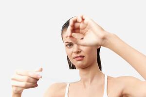 Disappointed woman holding a test result, displaying a negative reaction The clean white background photo