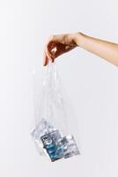 Bag full of pills held by a person on a white background with copy space. medical concept image. photo