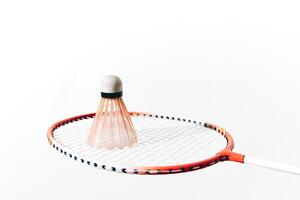 Badminton racket and shuttlecock on white background, shuttlecock hitting the racket. a close-up photo