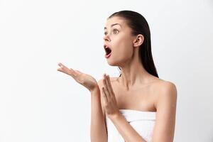 surprised woman with open mouth on a plain white background, she is expressing shock and curiosity photo