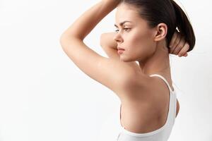 A young woman strikes a graceful pose against a plain white backdrop Her simple, elegant look photo