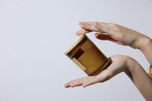 Honey jar in person's hand on white background with space for text. concept of natural food, sweet photo