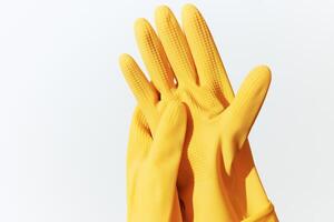 Rubber gloves in yellow color on a white background. 3d ing. photo