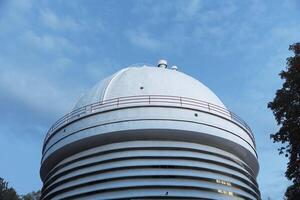 Modern architectural design with a stunning white dome crowning a building, complemented by a photo