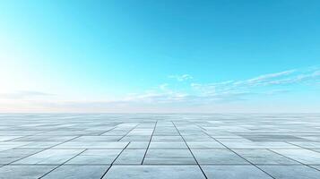 Expansive gray floor tiles with a bright blue sky above, creating a serene and open atmosphere. photo