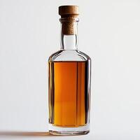 Elegant glass bottle filled with amber liquid on a white isolated background. photo