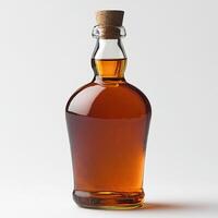 Stylish glass bottle filled with amber liquid on a white isolated background. photo