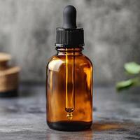 Amber glass dropper bottle with black lid on a rustic surface, ideal for oils or serums. photo