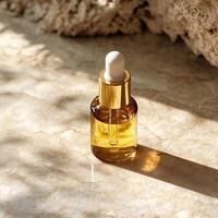 Elegant glass dropper bottle with gold accents on a marble surface, capturing the essence of luxury skincare. photo