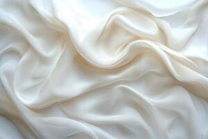 Soft, flowing white fabric texture with gentle waves and elegance, ideal for backgrounds and overlays. photo