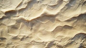 Textured sandy surface under sunlight, ideal for backgrounds or design elements. photo