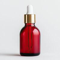 Red glass dropper bottle with white pipette, elegant design on isolated background. photo