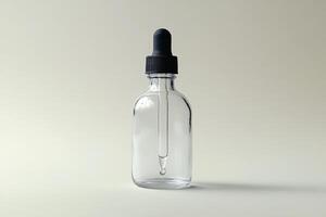 Clear glass dropper bottle with a black lid, isolated on a soft color background. photo