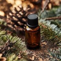 Essential oil bottle on natural backdrop of pine branches and cones, showcasing nature's tranquility. photo