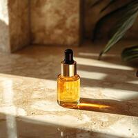 A beautiful golden liquid dropper bottle set on a marble surface with natural sunlight illuminating its elegance. photo