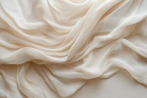 Elegant cream fabric draped softly, highlighting smooth texture and delicate folds, perfect for design. photo
