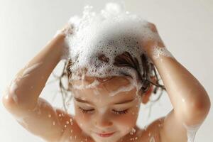 Child playing with bubbles while washing hair, joyful moment, white isolate background. photo