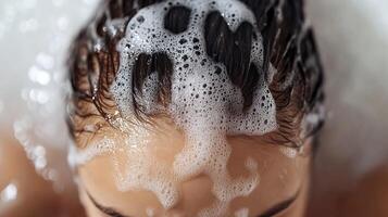 Close-up of a person washing hair with shampoo and bubbles, relaxing moment with foamy scalp. photo