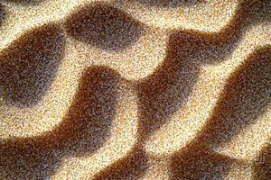 Abstract patterns in sandy texture with natural shadows and light reflections, creating a unique visual effect. photo