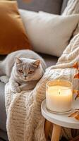 Cozy living room scene with a cat relaxing next to a candle on a table, creating a warm atmosphere. photo