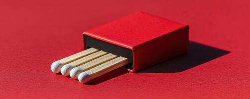 Minimalist matchbox on red surface, vibrant contrast, modern design photo