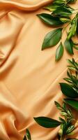 Elegant green leaves arranged on soft golden fabric, creating a serene and natural composition. photo