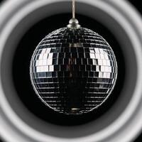 Glossy disco ball against a solid black backdrop photo
