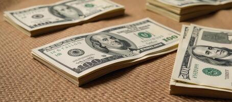 Dollar bills stacked on burlap evoking themes of bribes or bonuses photo
