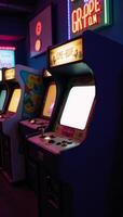 Vibrant photo captures retro arcade machine amidst glowing neon lights within a dark arcade